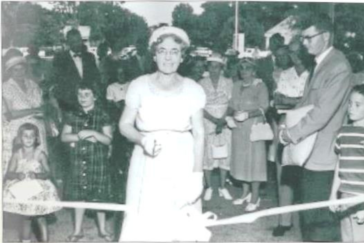 Mrs. George E. Weems is shown above cutting the ribbon at the official opening of the George E. Weems Memorial Hospital June 21, 1959.