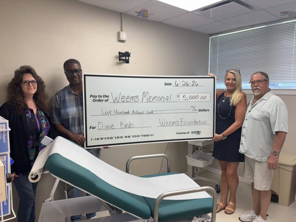 Weems Memorial Healthcare Foundation presents $5,000 check to George E. Weems Memorial Hospital for new West Clinic exam room bed